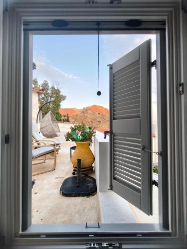 a window view of a patio with a vase at "Villa Kanella"Sea View Hydra Kamini malouholidays in Hydra
