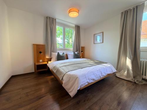 a bedroom with a bed and a large window at Lakeside No 9 in Hagnau