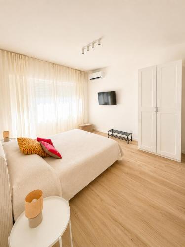 a bedroom with a large bed and a table at Casa Granata in Caserta