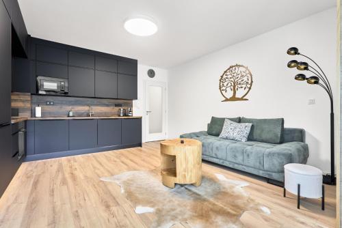 a living room with a couch and a table at Apartmány Krušec by Mountain ways in Plešivec