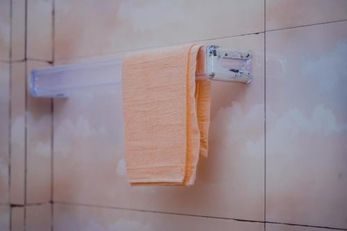 a towel hanging on a towel rack in a bathroom at Jaffna Gateway Hotel and Restaurant in Kanakarayankulam