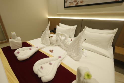 a hotel room with white towels on a bed at LUXURIA INN By CHANDAN in Junagadh