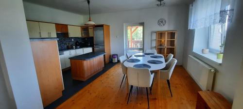 a kitchen with a table and chairs in a room at Chalupa Lipiny in Nečín