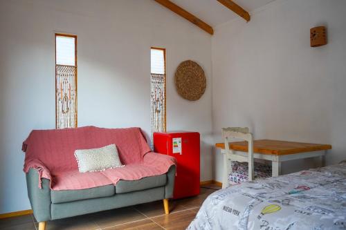 a living room with a couch and a red refrigerator at Río Luna cabaña 2 in Diaguita