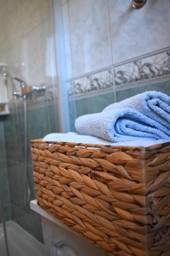 a basket with towels in a bathroom with a shower at Apartmani Benedetti in Povljana