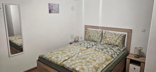 a bedroom with a bed and a mirror in it at Студио МИНЕРА in Kyustendil