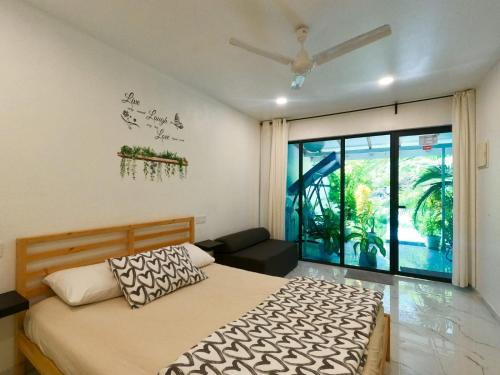 a bedroom with a bed and a ceiling fan at Oceana Surf Maldives - Kudahuvadhoo Island Surf Retreat in Kudahuvadhoo
