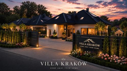 a villa krakow with a sign in front of a house at Villa Kraków in Krakow