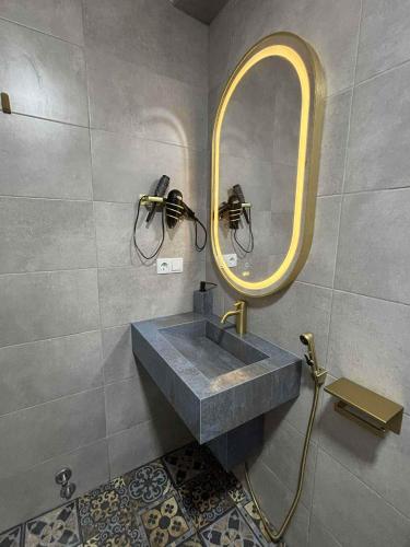 a bathroom with a sink and a mirror at Дом Sand in Ureki