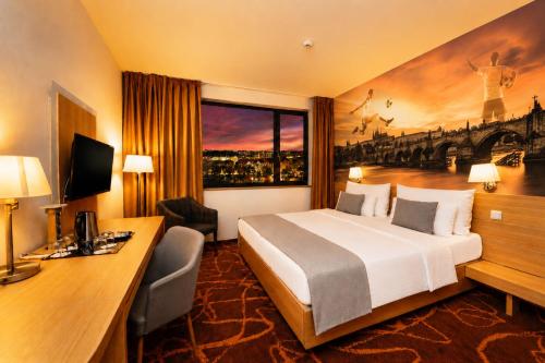 a hotel room with a bed and a desk at Iris Hotel Eden - Czech Leading Hotels in Prague