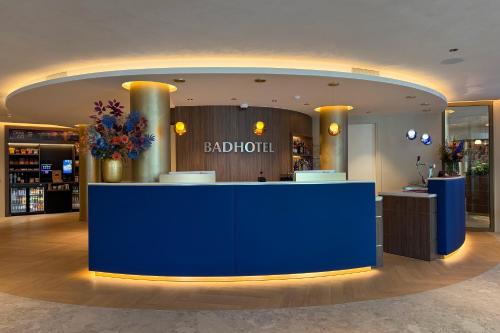 a bar in a hotel lobby with a blue counter at TRYP Badhotel The Hague Scheveningen BRAND NEW in Scheveningen