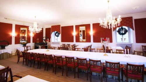 a large dining room with a large table and chairs at Kokkedal Slotshotel in Brovst