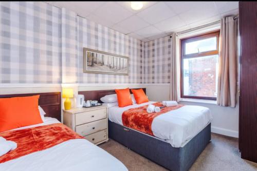 a bedroom with two beds and a window at The Sonora Park Contactless Hotel by BET stays in Blackpool