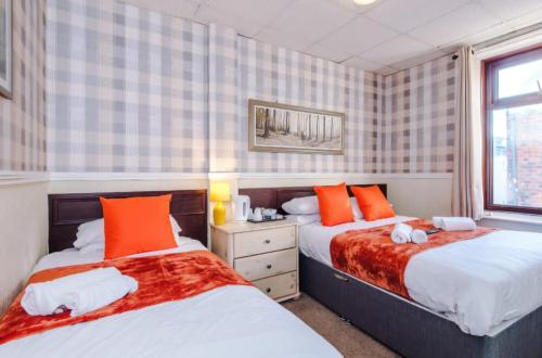 a bedroom with two beds and a window at The Sonora Park Contactless Hotel by BET stays in Blackpool