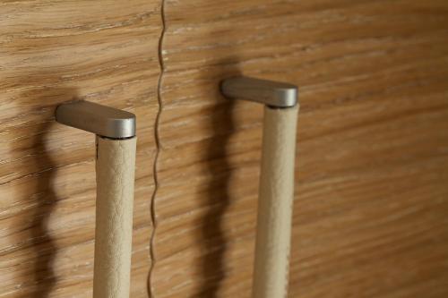 two metal stools on a wooden floor with a wire at Hotel C'era Una Volta in Castiglione della Pescaia