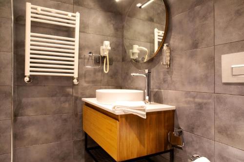 a bathroom with a sink and a mirror at Sör Apart Otel in Bodrum City