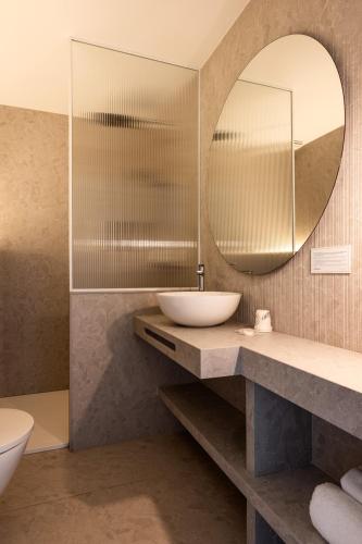 a bathroom with a sink and a mirror at Can Miquel in L'Escala