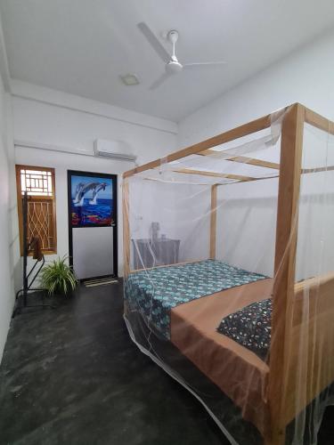 a bedroom with a bunk bed in a room at Kanthans Lighthouse Cabanas in Komari