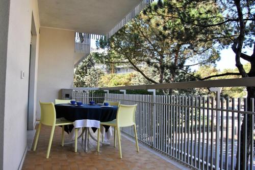 a dining table and chairs on a balcony at Residence Braida in Caorle