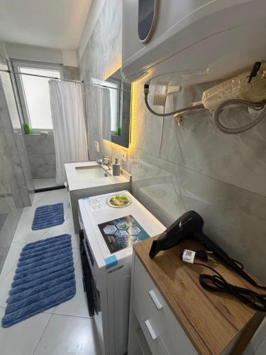 a small kitchen with a stove and a sink at Blue luxury apartment Kune in Sakës