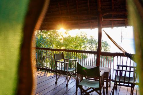 a view of a porch with chairs and a table at Kitu Kiblu in Kilindoni