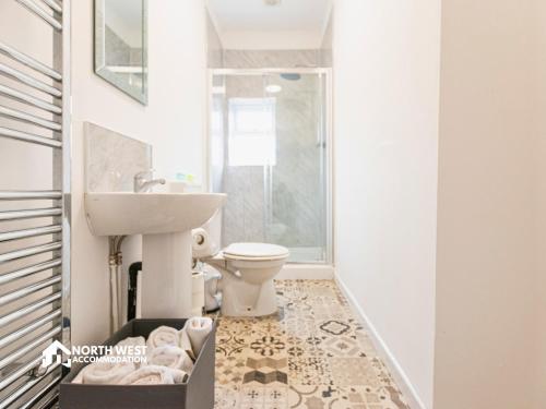 a bathroom with a sink and a toilet at Modern 2-Bedroom Home in Bolton Spacious & Comfortable in Bolton