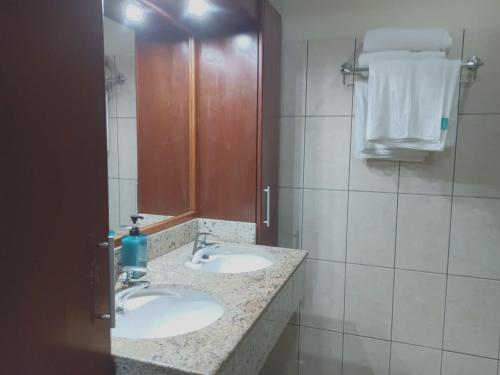 a bathroom with two sinks and a mirror at POCO POCO Villa - Poolside Golf & Beachfront Resort in Dorp Sint Michiel