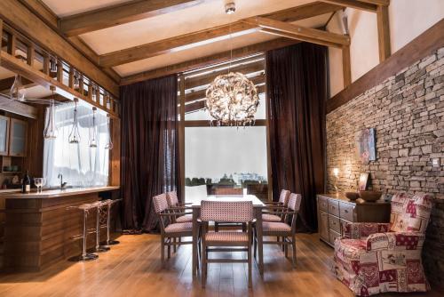 a dining room with a table and chairs at Villa Nataly at Golf Resort in Bansko