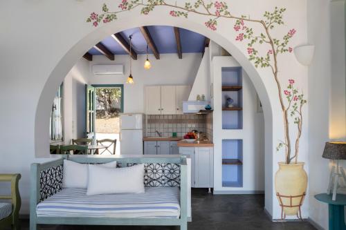 a living room with an archway and a couch at Nefeli Hotel Leros in Agia Marina