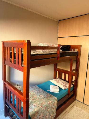 two bunk beds in a room with a bed at Casa de Gente Feliz in Cuiabá