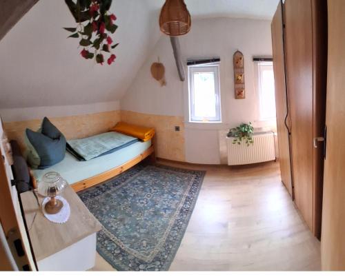 a small room with a bed and a rug at Fewo am Wasserrad in Ruhla