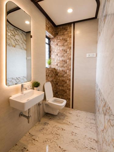 a bathroom with a sink and a toilet at Transit Seven Hills Hotel Near Airport Mumbai T2 in Mumbai