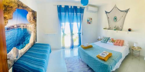 a bedroom with a bed and a large window at Casa Sea view Blu Marettimo in Marettimo