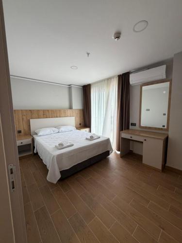 a bedroom with a large bed and a large mirror at Mimoza Apart in Trabzon