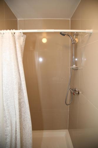 a shower with a shower curtain in a bathroom at A Gosport Inn in Gosport