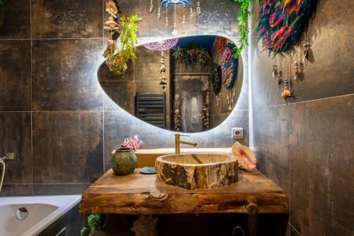 a bathroom with a wooden sink and a mirror at Avataar - L'arbre de Pandoraa in Belfort