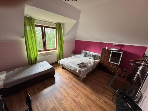 a bedroom with two beds and a window with green curtains at Guesthouse Sauna Jacuzzi Free parking in Dobrzewino