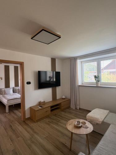 a living room with a flat screen tv on the wall at Azyl na statku 5 in Pardubice