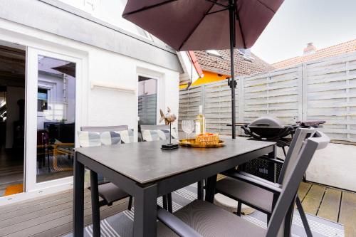 a table with an umbrella on a patio at Haus 1805 Fehmarn in Fehmarn