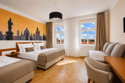 a hotel room with two beds and a couch at Hotel Merkur - Czech Leading Hotels in Prague