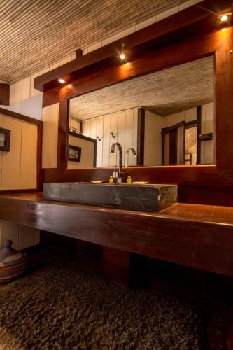 a bathroom with a sink and a mirror at Anchaca Sul in Bubaque