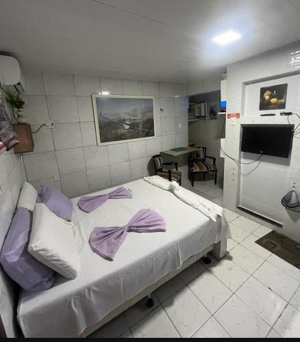 a hospital room with a bed with purple sheets at Pousada do Benzinho in Cabedelo