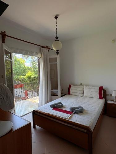 a bedroom with a bed and a sliding glass door at House by the sea! in Platamonas