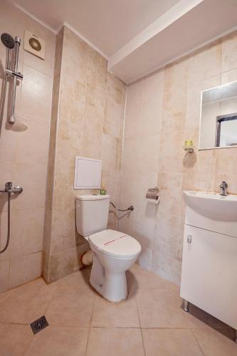 a bathroom with a toilet and a sink at Guest House Elidis in Primorsko