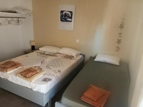 a bedroom with two beds with towels on them at ELENAs in Kallithea Halkidikis
