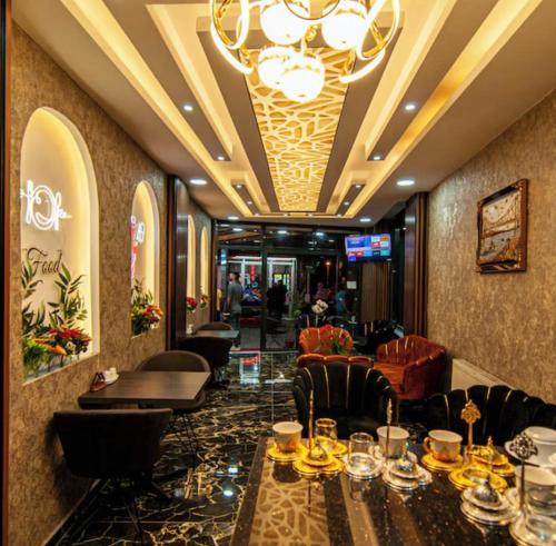 a restaurant with a table and chairs and a chandelier at Histavera Hotel in Istanbul