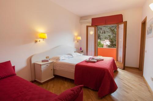 una camera d'albergo con letto e finestra di Hotel Le Rotonde a Massaciuccoli