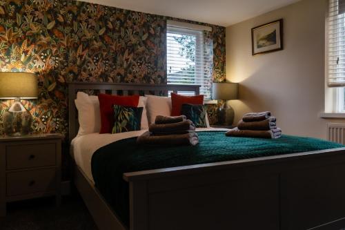 a bedroom with a bed with pillows on it at The Music Rooms in Bewdley