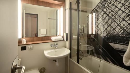 a bathroom with a sink and a toilet and a shower at Campanile Lyon Centre - Berges du Rhône in Lyon