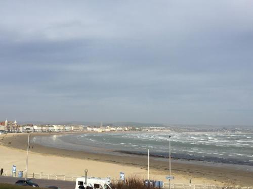 a view of a beach with the ocean and buildings at The Chatsworth in Weymouth